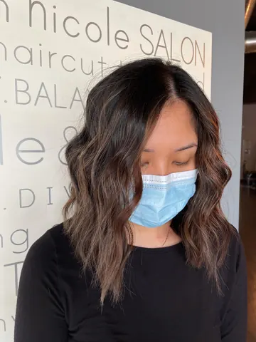 Dark brunette waves with subtle caramel balayage ends